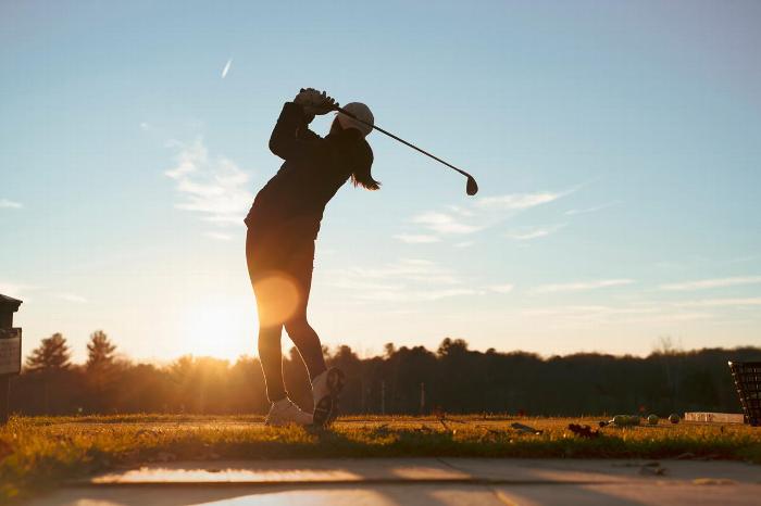 A golfer teeing off